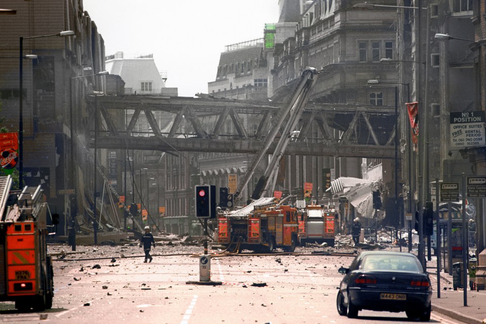  Firemen at the scene of the IRA bomb blast in Manchester city centre in 1996