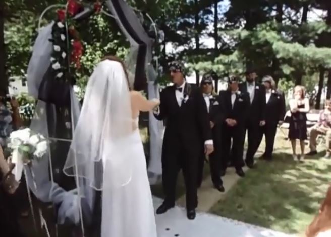 She greeted by her future husband and groomsmen all wearing bandannas