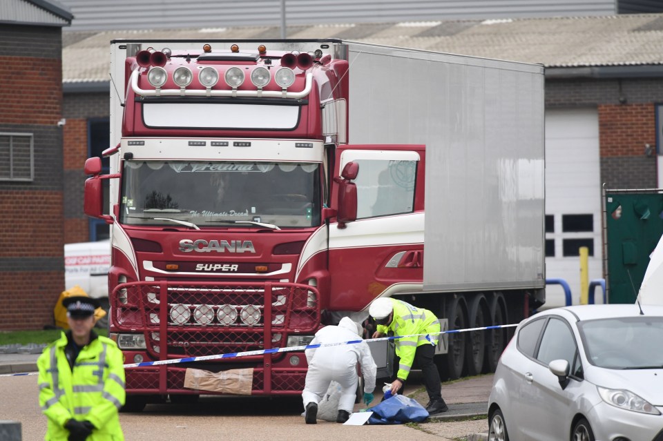 Forensic experts examine the lorry discovered in Essex with the bodies of 39 migrants inside