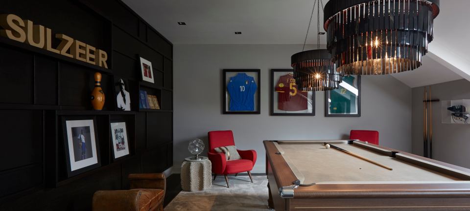  Dotted around the house's games room are framed football shirts