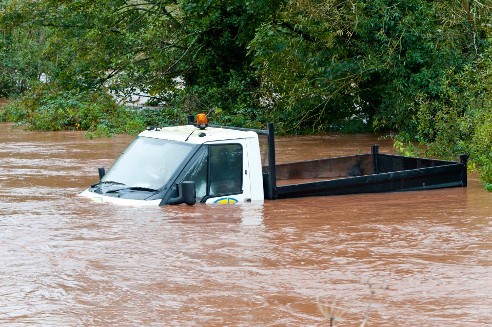  A truck is engulfed by flood water as rain falls relentlessly and the level of the river Usk rises dramatically