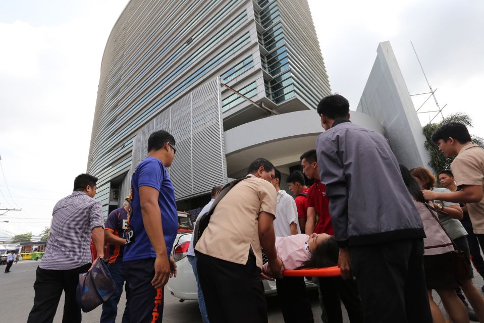  A woman is carried from an office building in a stretcher after the 6.6 magnitude quake struck