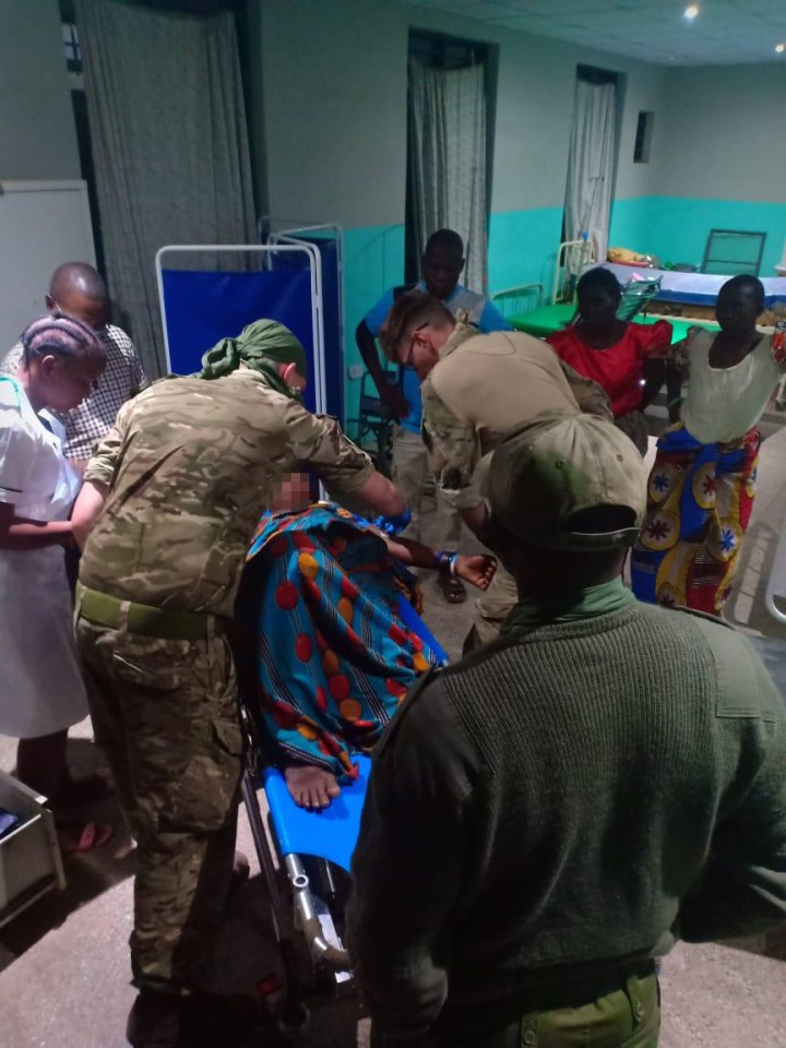  The two British Army Medics - pictured helping the woman - simply say: 'We got on with providing the treatment she required'