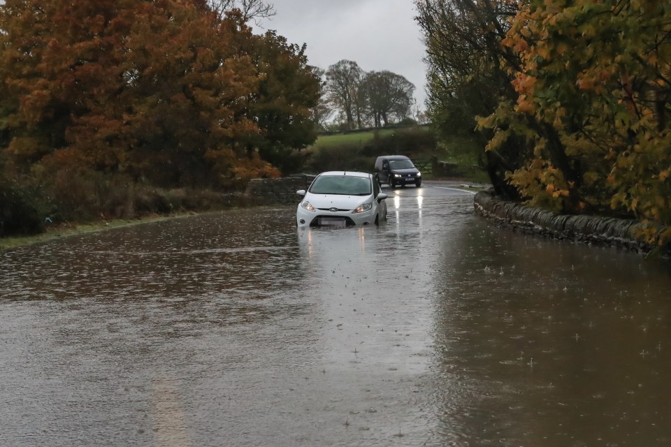  Heavy rain causes floods as a car gets stranded in floodwater in Barnsley