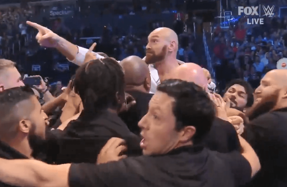  Fury stared Strowman down as he was led away by as many as a dozen security guards