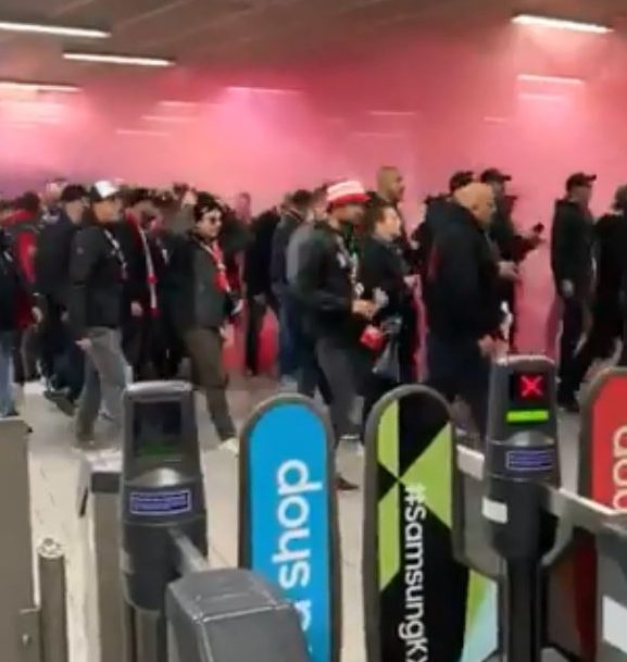  Footage shows fans walking through a smoke-filled King's Cross Tube station in London today