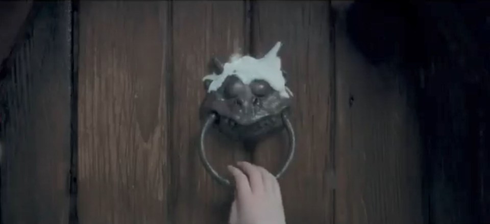 The teaser focuses on a snow covered dragon shaped door knocker