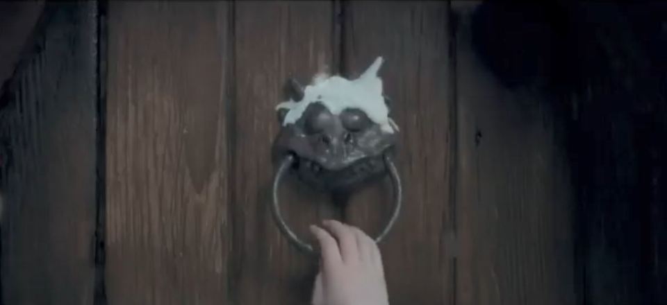  The teaser focuses on a snow covered dragon shaped door knocker