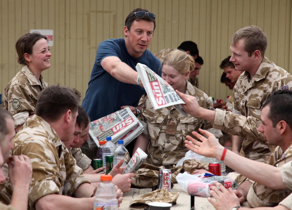  Defence Editor Tom Newton Dunn hands out The Sun at Camp Bastion, Afghanistan, 2009