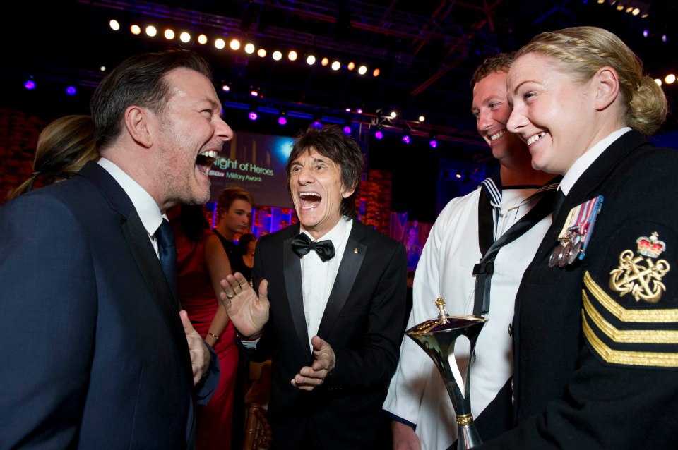  Ricky Gervais and Ronnie Wood joke with prize winner Petty Officer Emily McCullough at the 2013 Millies