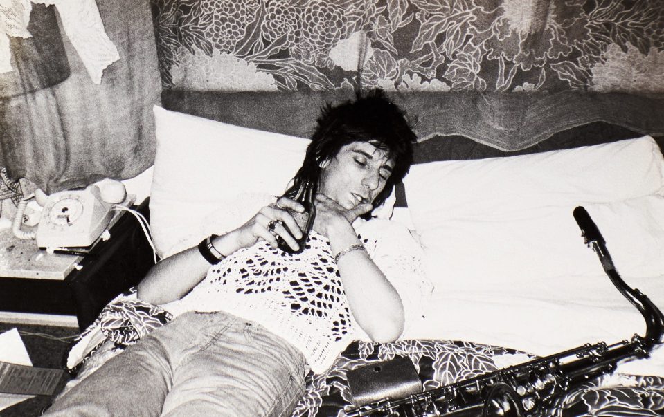  'Ronnie, asleep with a beer and his beloved saxophone. It had once belonged to Plas Johnson, who played the original Pink Panther theme. The Stones sax player Bobby Keys found this rare instrument for me'