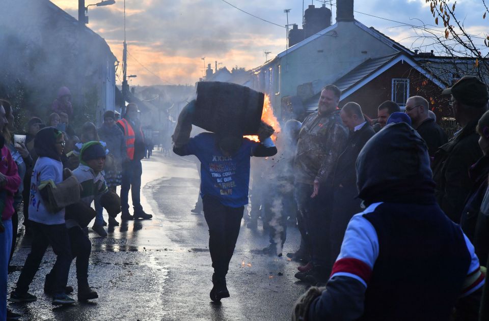  This annual celebration sees local men and women carry flaming barrels coated in tar through the town's streets