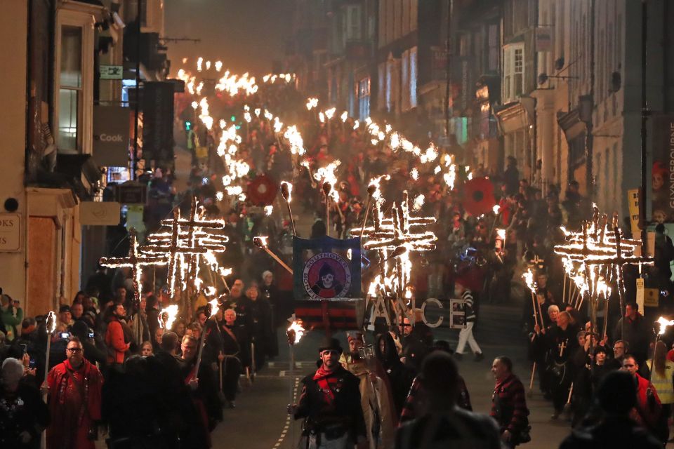  Lewes' streets were filled with locals as they paraded with burning crosses ahead of the bonfire night