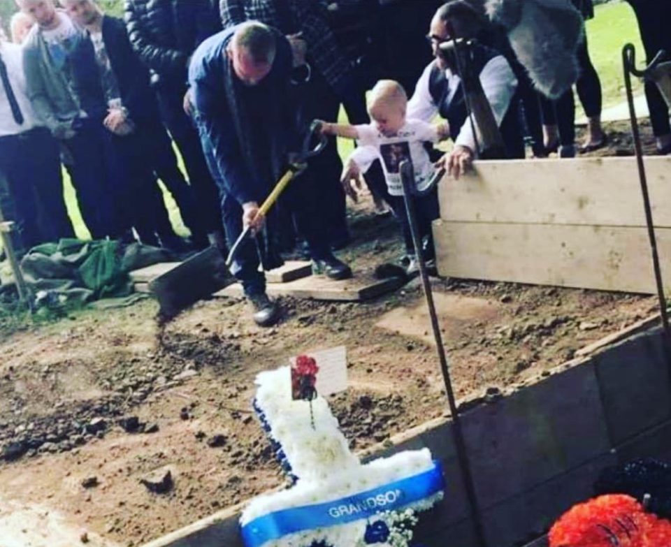  This heartbreaking photo of little Carter helping to dig his dad's grave went viral in September