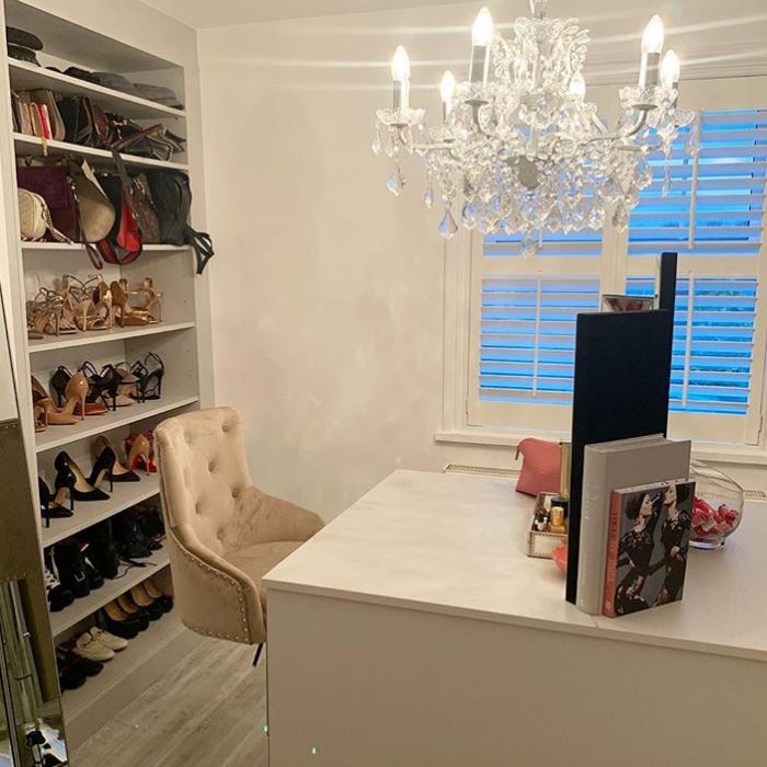  A velvet chair is perched beside a dressing table