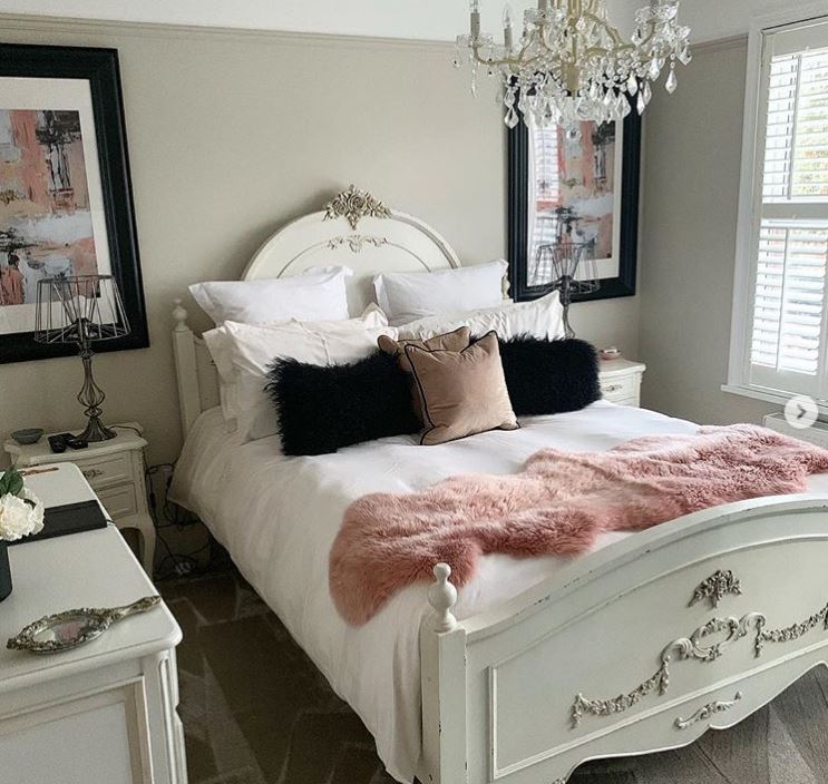  Matching framed artwork hangs either side of her bed