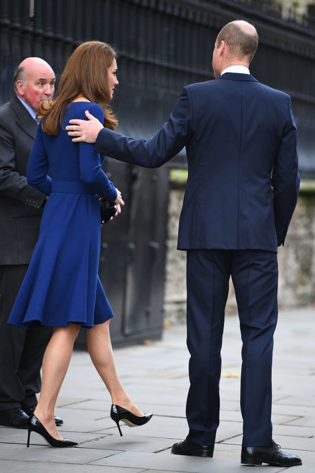 Prince William puts a hand on his wife's shoulder