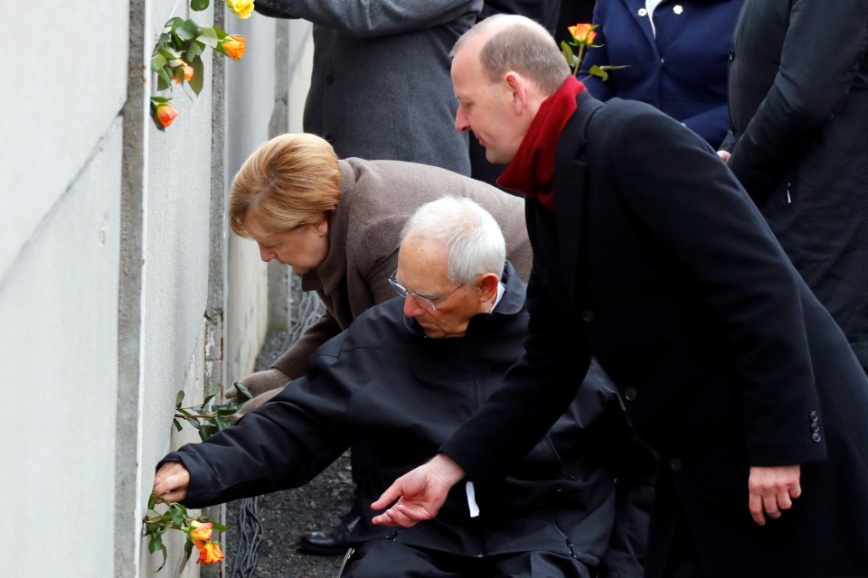  The German leader plants a rose on one of the last remaining sections of the wall at Bernauer Strasse in Berlin