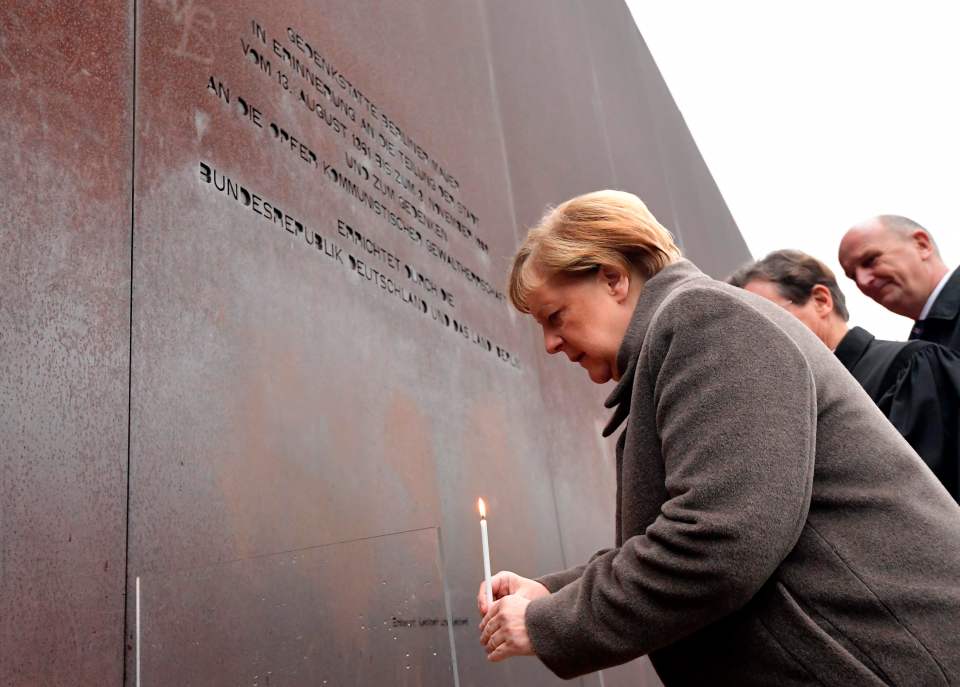  Merkel places a candle at the Berlin Wall Memorial today