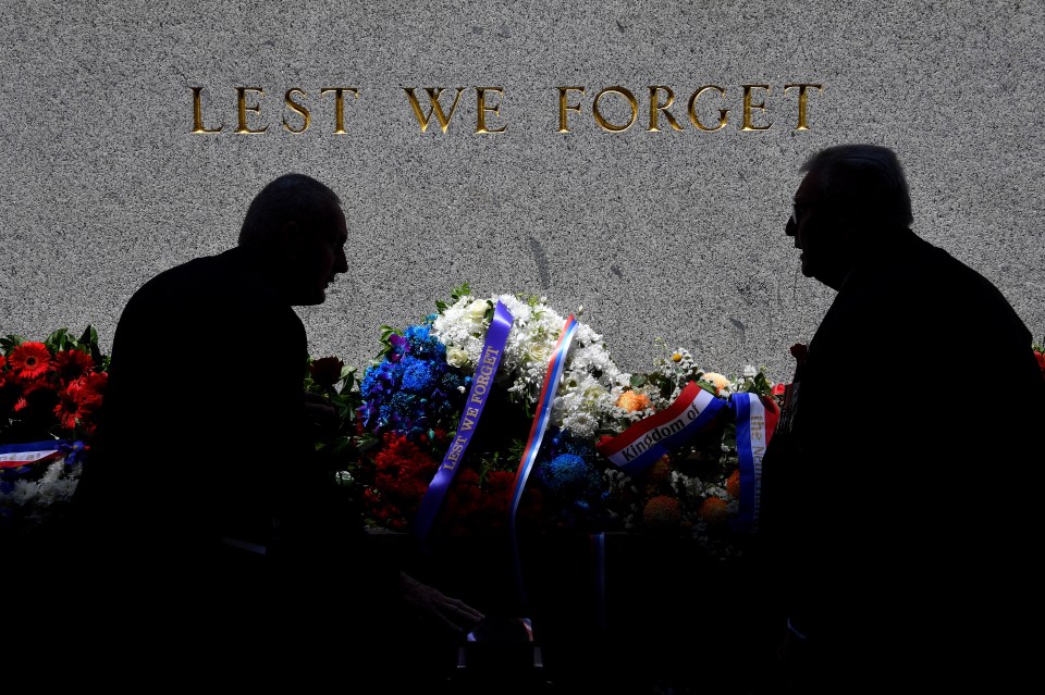  People lay wreaths during a Remembrance Day event at the Sydney Cenotaph in Sydney