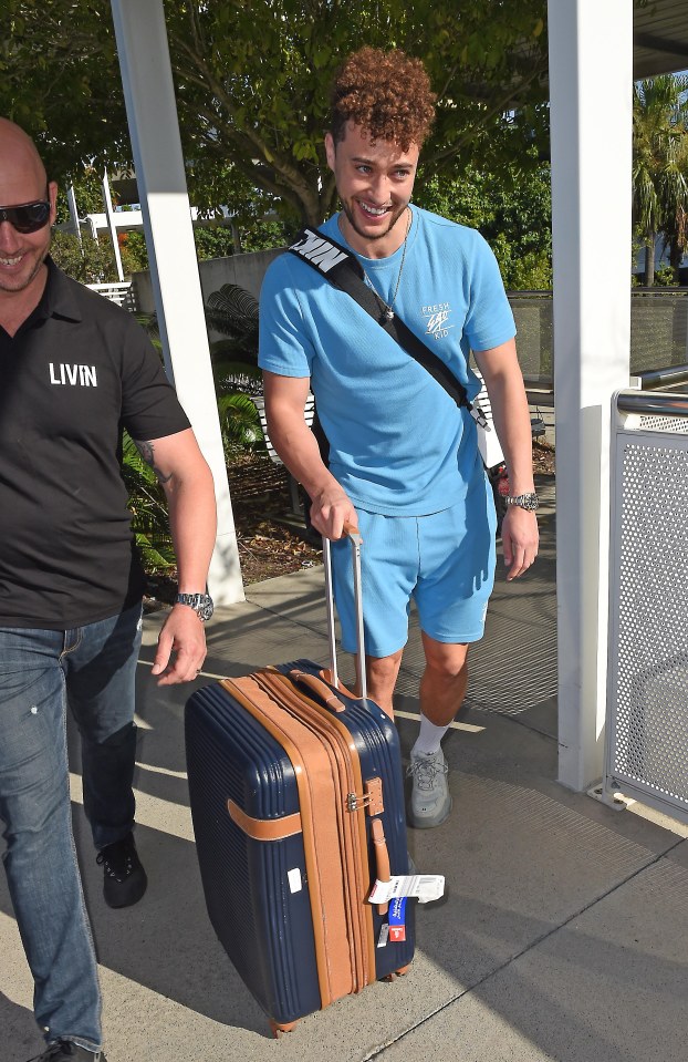  He showed off a big grin as he walked through arrivals