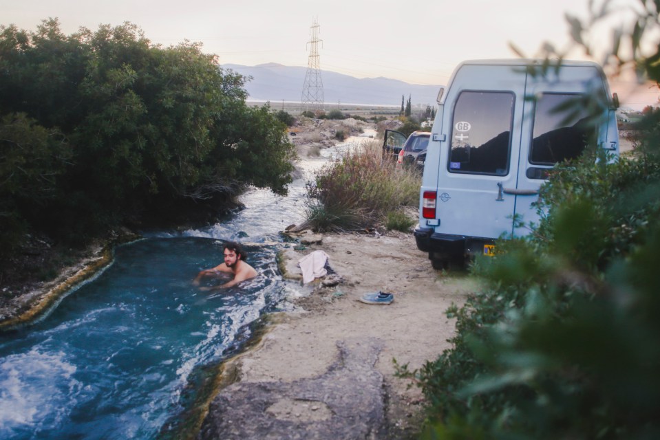  Ben going for a swim in Greek hotsprings after parking up in the van