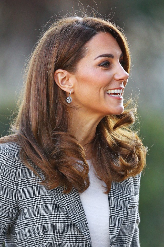 Kate Middleton smiles as she speaks to volunteers who have given up their time for the charity