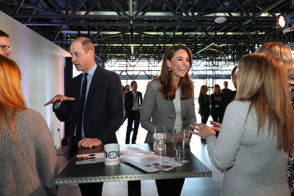 The duchess is seen laughing as she speaks to some of the volunteers