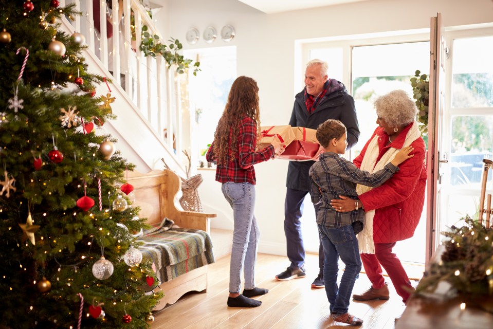 Grandchildren giving grandparents Christmas presents.