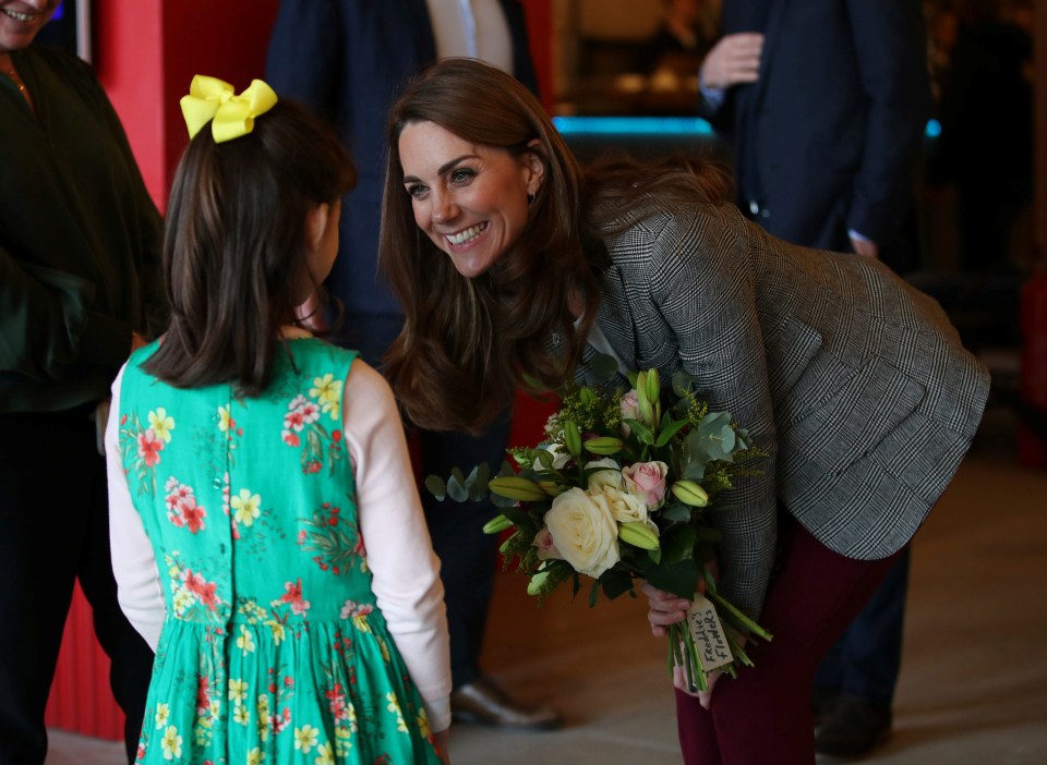 Kate Middleton bends down to chat to a young girl during the event