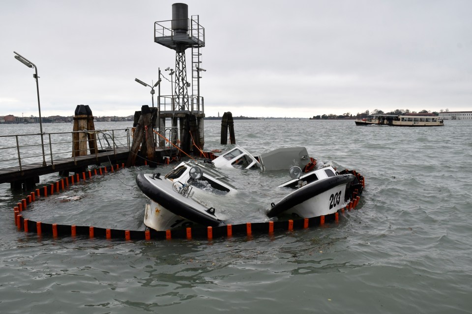  Partially submerged ferry boats caught up the flood chaos