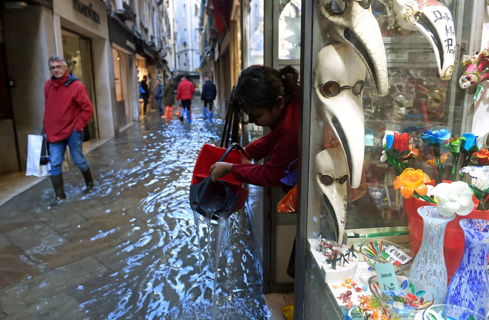  A woman cleans out her shop amid fears the flooding could have a major impact on the city's population