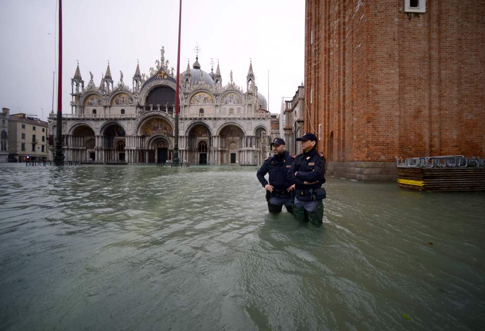  State-of-emergency... Police stand in the flooded St Mark's Square