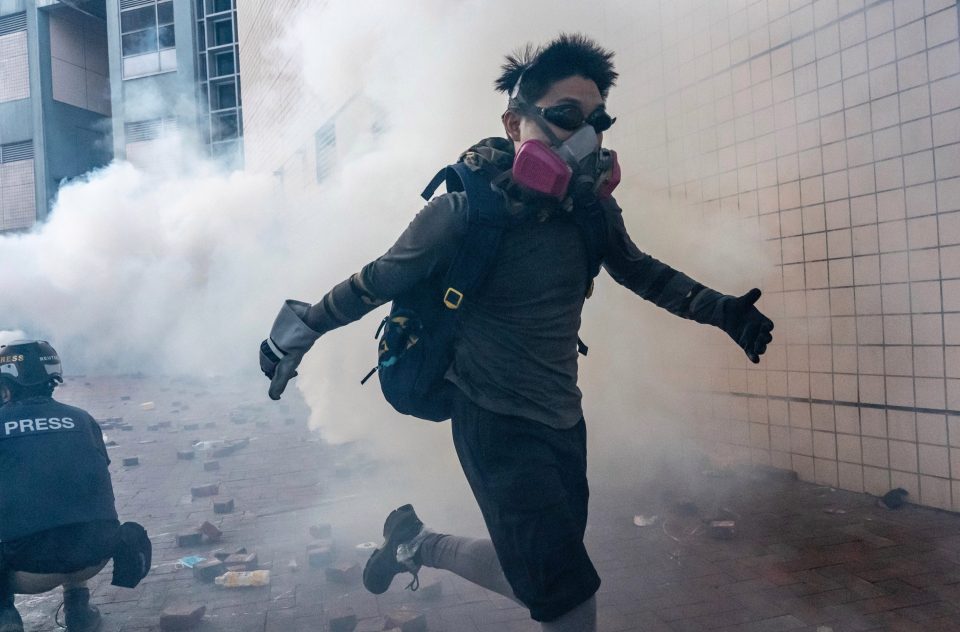  An activist flees the tear gas as tensions continue to escalate