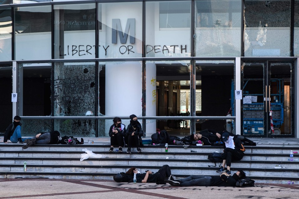 Protesters sit in the campus on the sixth day of protests