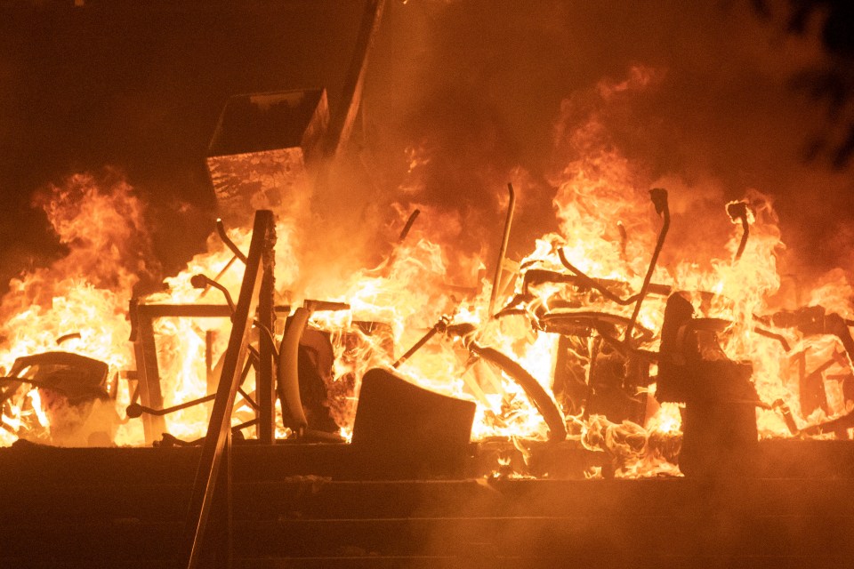  Desk chairs burn after police stormed the Hong Kong Polytechnic University on Monday