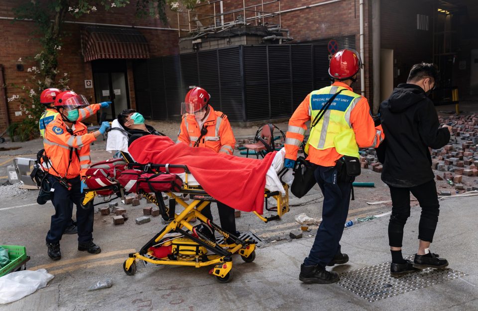  An injured protester is carried away on a stretcher at The Hong Kong Polytechnic University