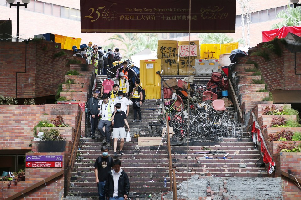  Protesters who surrendered to police leave the Hong Kong Polytechnic University