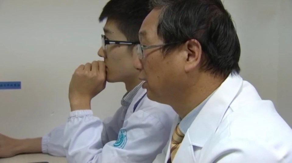  Dr Huang Jianrong, right, examining the scans with a colleague