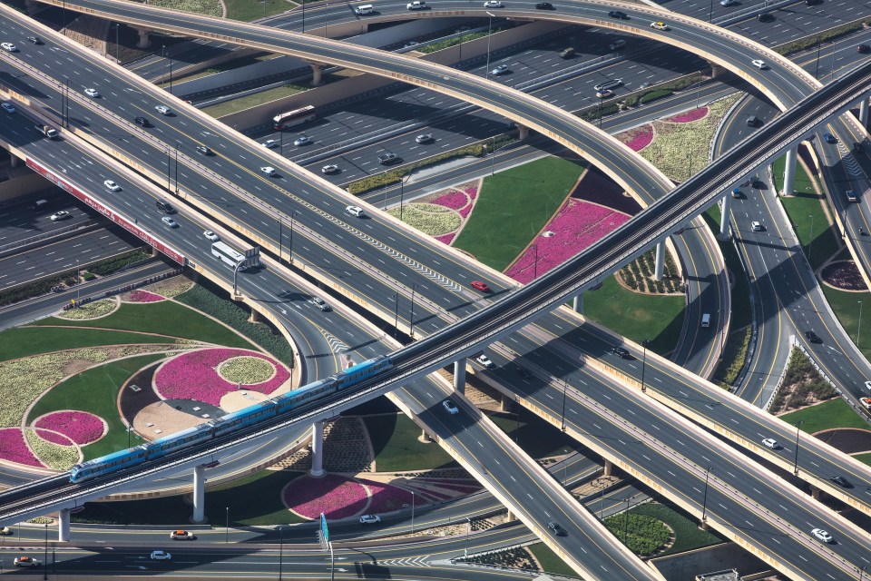  A fully automated metro rail line crosses over roads and a manicured garden in Dubai, UAE, September 2019