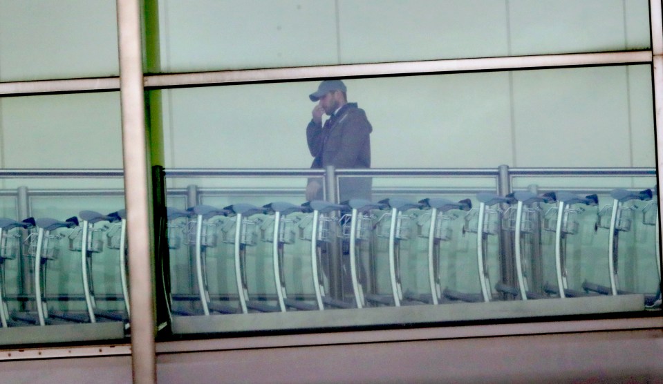  The mechanic conceals his identity with a baseball cap as he escapes Walford