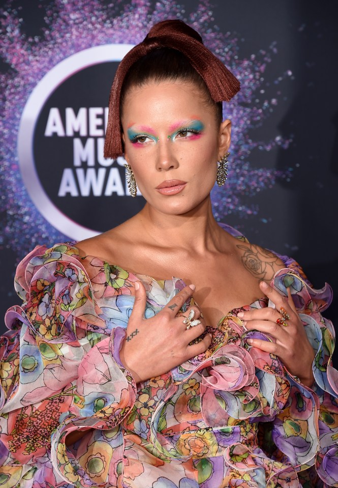  She accented the brows with blue and pink rainbow eye makeup to match her multicolored red carpet dress