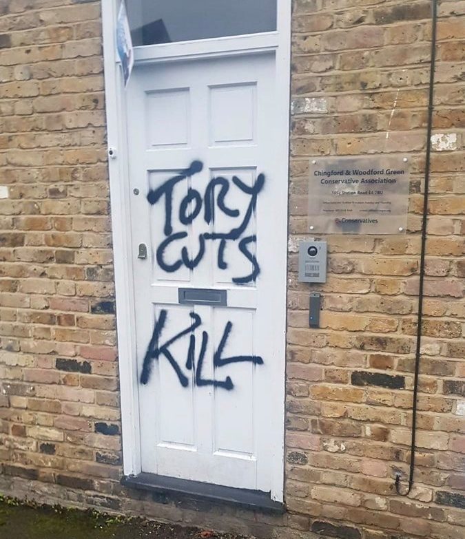  A single masked vandal scrawled slurs on the top Tory's door