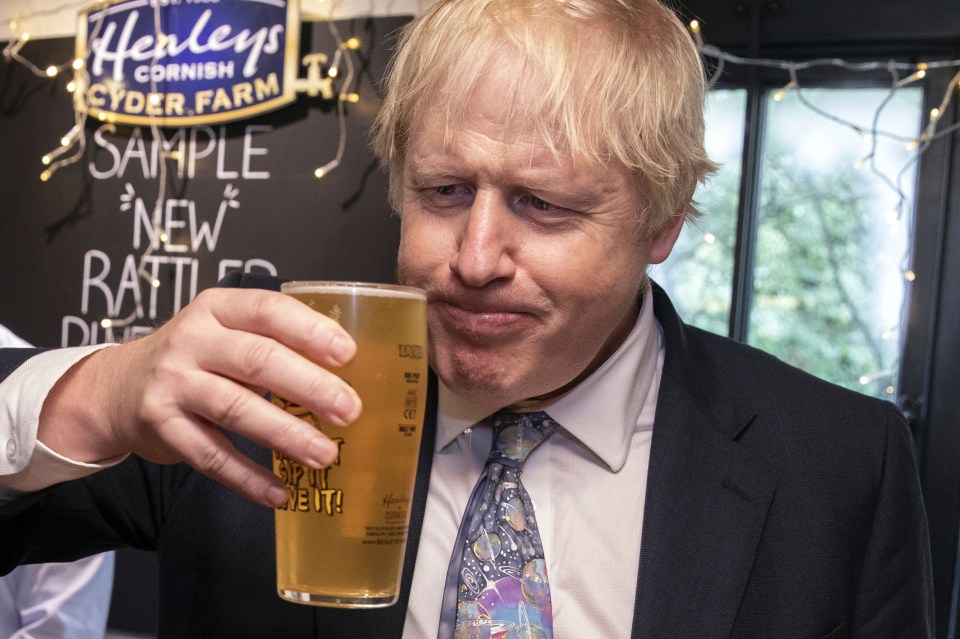  Boris Johnson samples a pint of cider in Cornwall after pledging to pour billions of pounds into the NHS, schools and the police