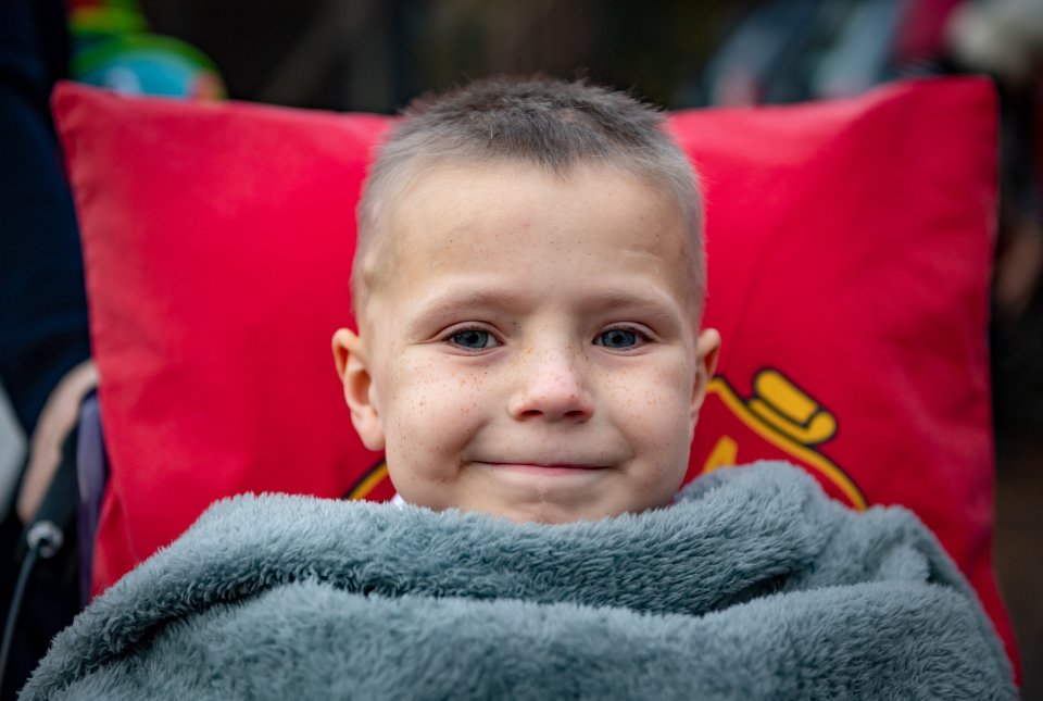  Ethan, eight, was in a wheelchair, and kept cosy with a blanket and Man United cushion