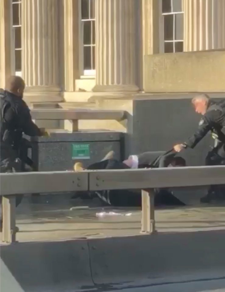  At 14:03 armed cops pull a member of the public off the attacker and see what appears to be a suicide vest