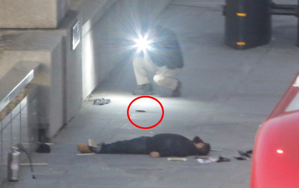  A man can be seen on the ground with a knife nearby