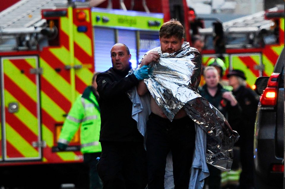  Paramedics and police assist injured members of the public after the attack