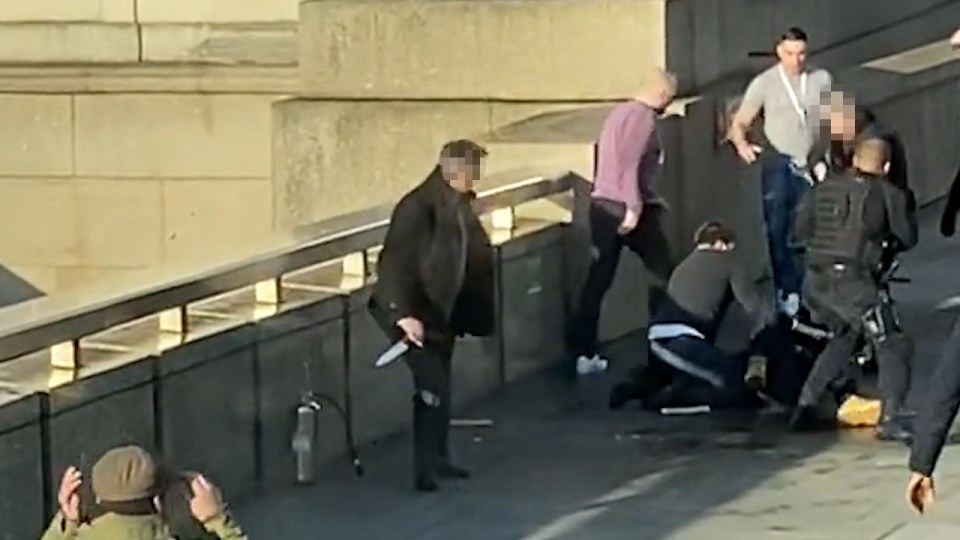  Brave passersby pin down jihadi Khan while another takes one of the killer's knives away