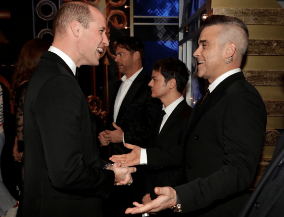  Prince William smiles as he meets Rock DJ singer Robbie Williams at the event